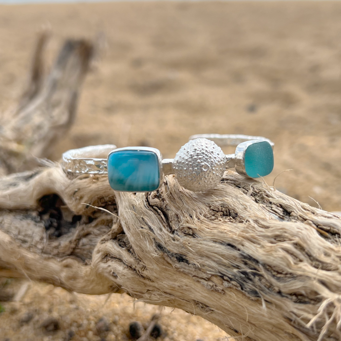 Sterling silver crushed texture cuff featuring a cast silver sea urchin shell, an ocean teal sea glass gem and natural Larimar.. 60cm diameter with a 3cm opening.By Mornington Sea Glass