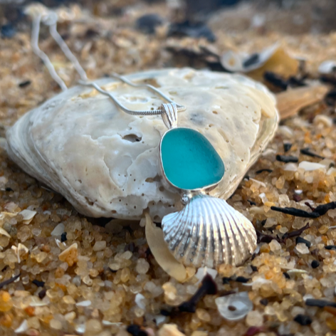 Sterling silver necklace of cast silver shell and ocean teal sea glass. Hangs on a 40 or 45cm sterling silver chain. By Mornington Sea Glass.