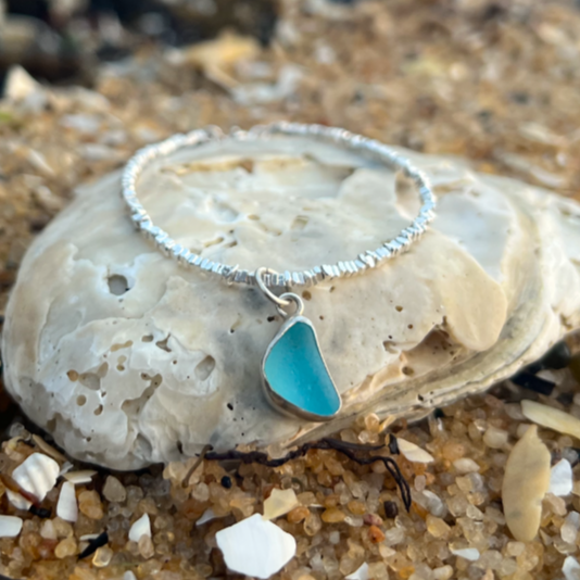 Blue sea glass set in silver surf bracelet by Mornington Sea Glass.