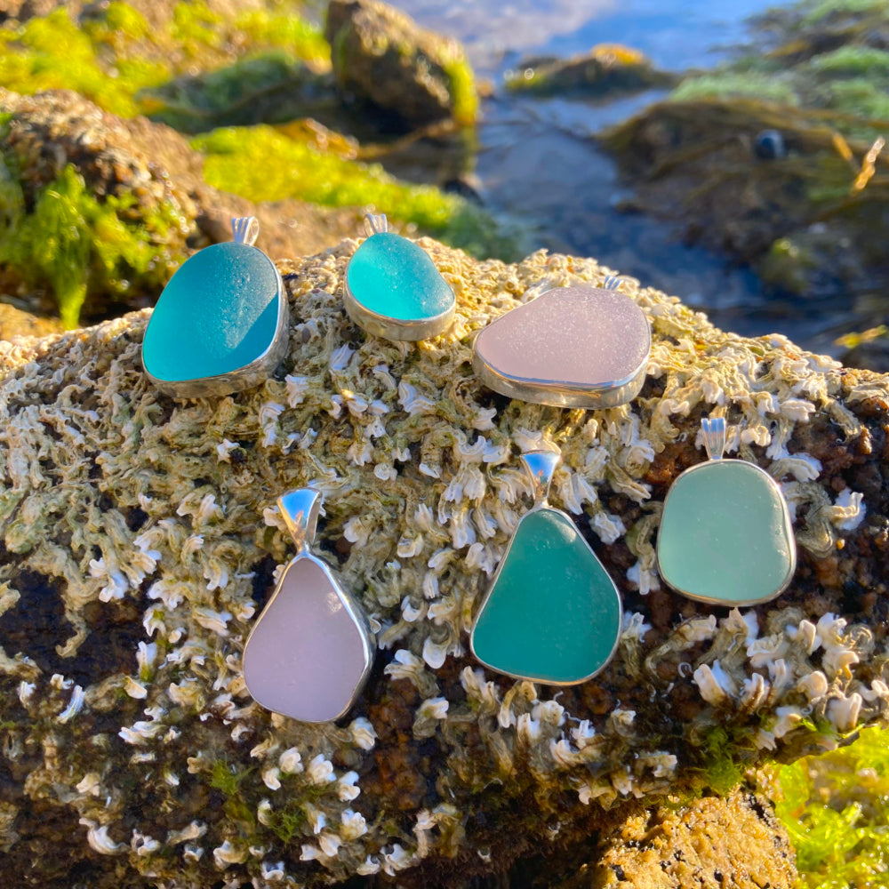 Purple, turquoise, aqua and blue sea glass pendants by Mornington Sea Glass photographed at rock pools on the Mornington Peninsula, Victoria, Australia