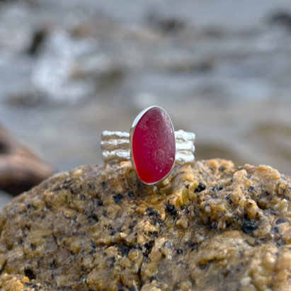 Rare red sea glass set in silver on a cast driftwood inspired silver ring band by Mornington Sea Glass. Size 8.