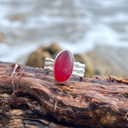 Rare red sea glass set in silver on a cast driftwood inspired silver ring band by Mornington Sea Glass. Size 8.