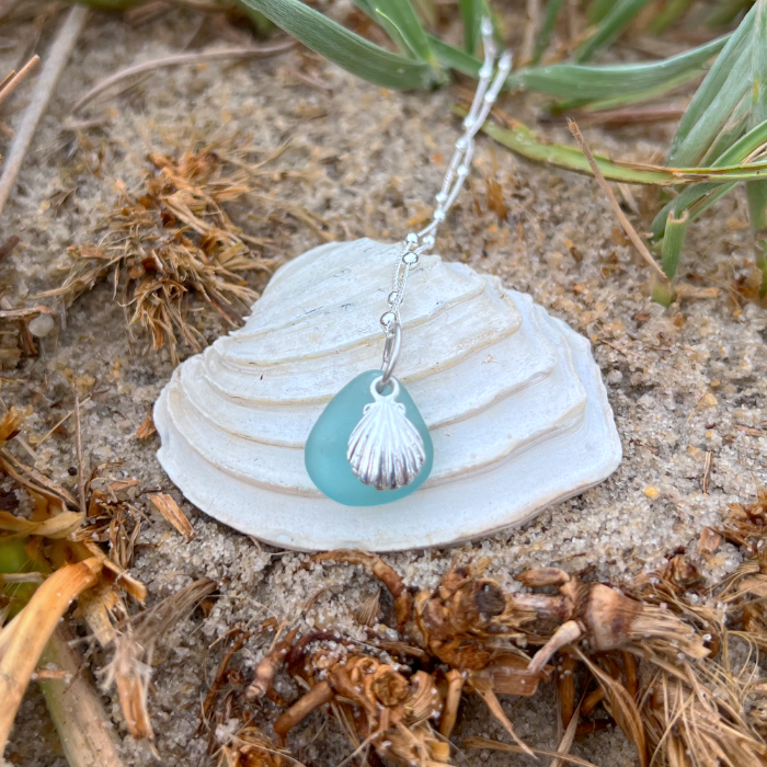 Ocean teal sea glass and sterling silver shell pendant by Mornington Sea Glass. Hangs on a 40cm + 5cm extension ball detail chain.