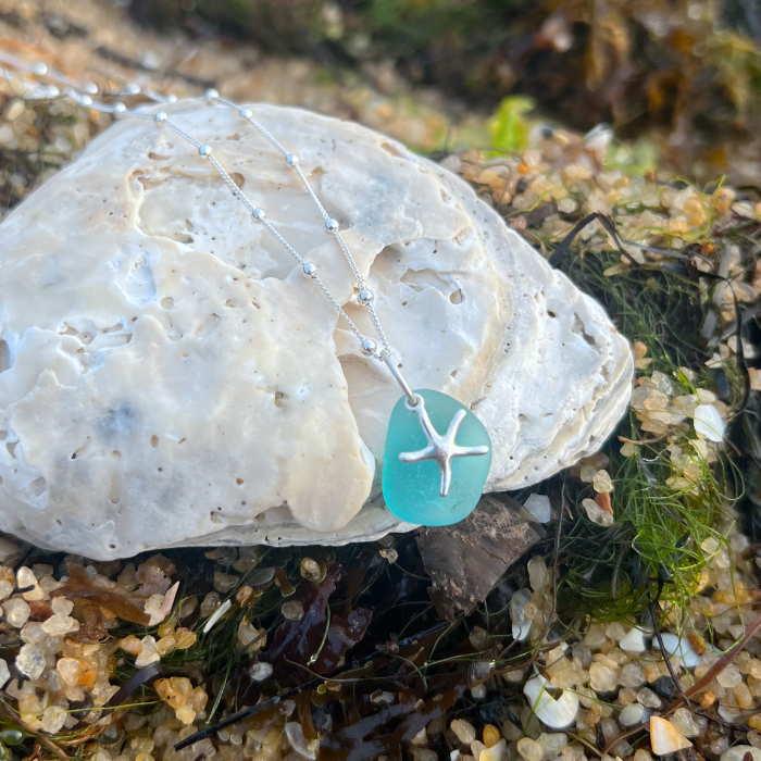 Ocean teal sea glass and sterling silver starfish pendant by Mornington Sea Glass. Hangs on a 40cm + 5cm extension ball detail chain.
