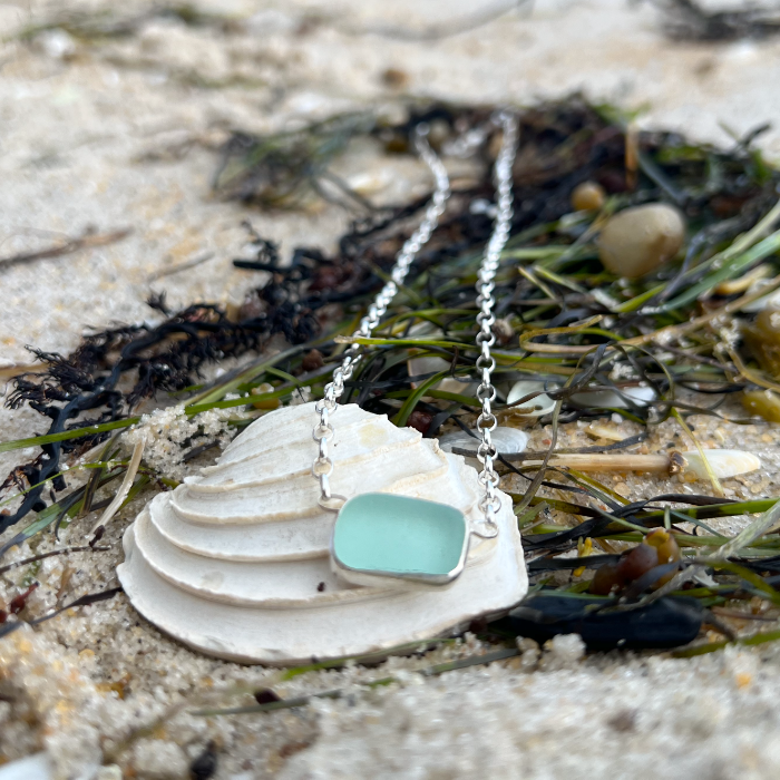 Seafoam sea glass set in silver pendant by Mornington Sea Glass. Hangs on a 40cm sterling silver belcher chain.