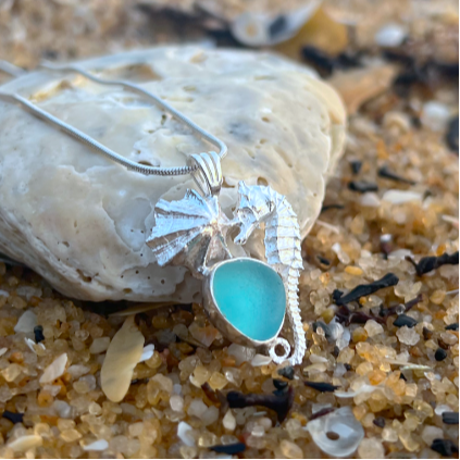 Sterling silver necklace of a small cast silver seahorse, limpet shell and blue sea glass treasure. Hangs on a 40 or 45cm sterling silver chain. By Mornington Sea Glass.