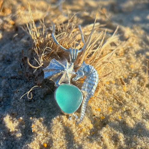 Sterling silver necklace of a small cast silver seahorse, limpet shell and blue sea glass treasure. Hangs on a 40 or 45cm sterling silver chain. By Mornington Sea Glass.