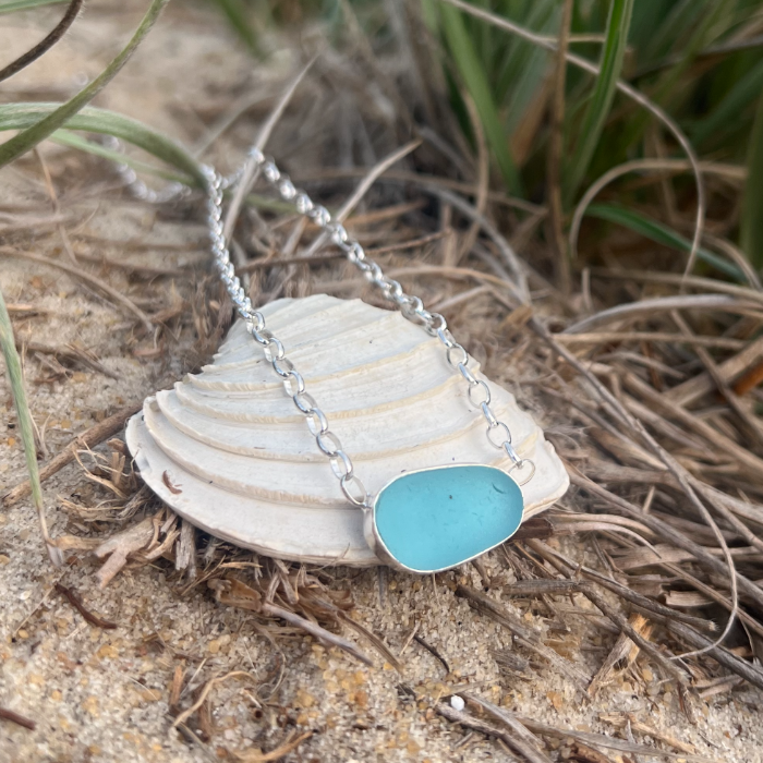 Ocean blue sea glass set in silver pendant by Mornington Sea Glass. Hangs on a 40cm sterling silver belcher chain.