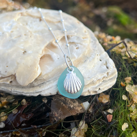 Blue sea glass and sterling silver shell pendant by Mornington Sea Glass. Hangs on a 40cm + 5cm extension ball detail chain.