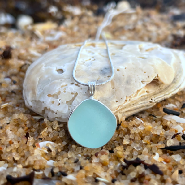 Soft blue sea glass set in silver pendant by Mornington Sea Glass. Hangs on 40cm or 45cm sterling silver snake chain.