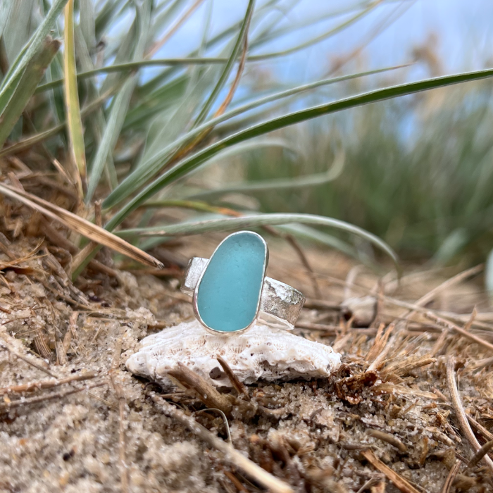 Teal blue sea glass set in silver on a hammered silver ring band by Mornington Sea Glass. Size 8 1/2