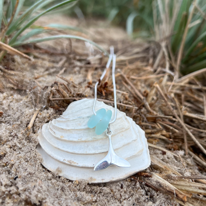 Soft blue sea glass and silver whale tail charm necklace by Mornington Sea Glass. Comes with a 40 or 45cm sterling silver snake chain.