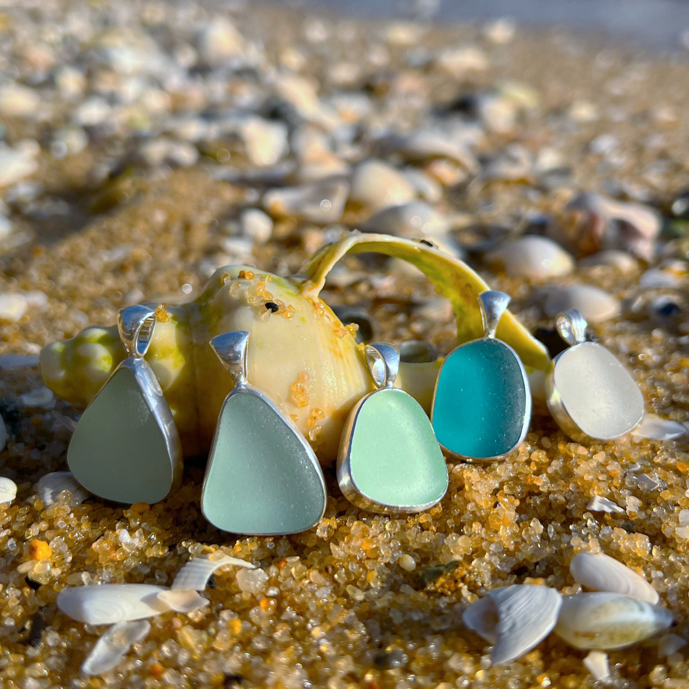 Sea glass set in silver pendants by Mornington Sea Glass.