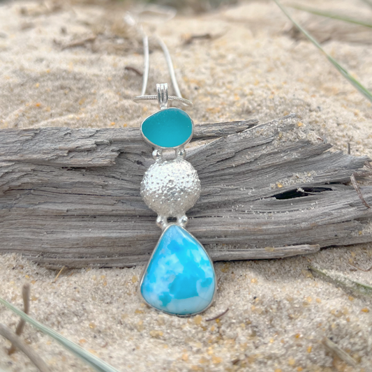 Sterling silver necklace of cast silver sea urchin shell, blue sea glass and Larimar. Hangs on a 40 or 45cm sterling silver chain. By Mornington Sea Glass.