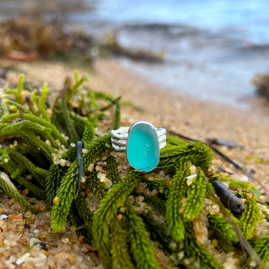 Blue sea glass set in silver on a cast driftwood inspired silver ring band by Mornington Sea Glass. Size 6 3/4.