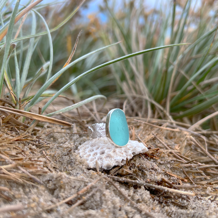 Blue sea glass set in silver on a cast beach feather inspired silver ring band by Mornington Sea Glass. Size 7 3/4.