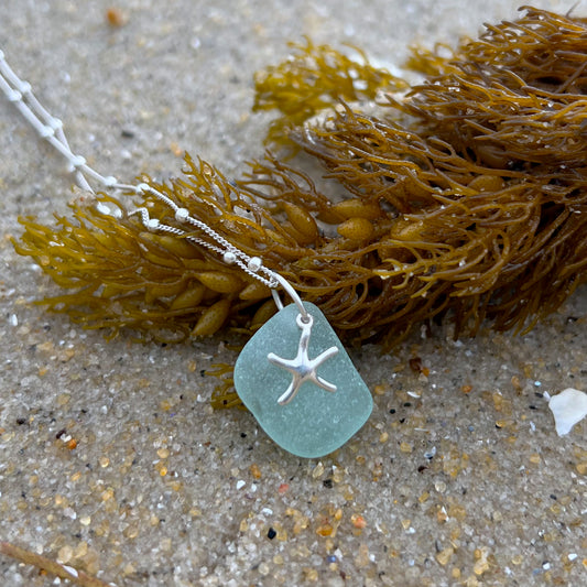 Soft blue sea glass and silver sea star pendant  by Mornington Sea Glass. Hangs on a 40cm sterling silver bola detail chain with 5cm extension.