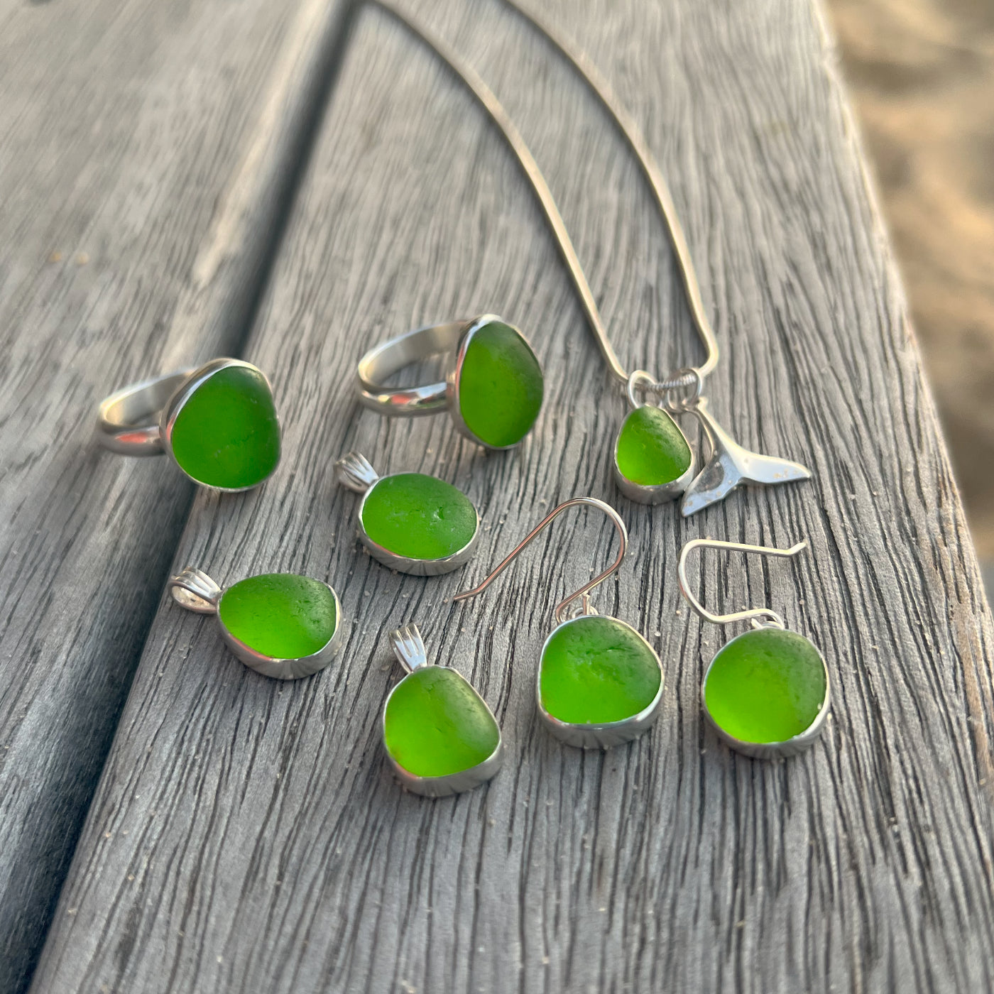 Collection of green sea glass set in silver jewellery including rings, pendants and earrings  by Mornington Sea Glass.