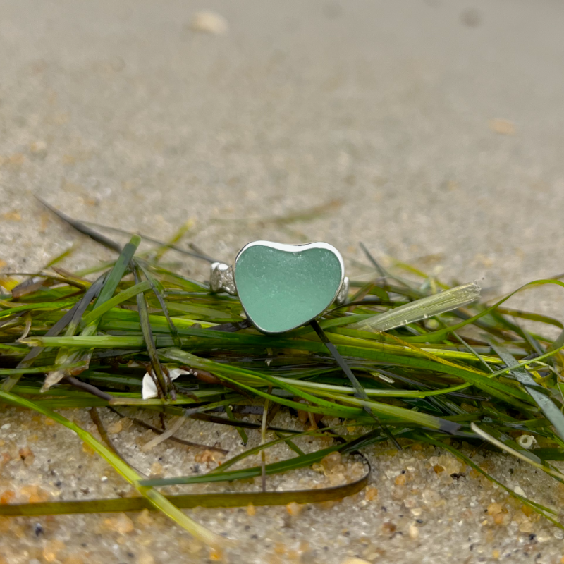 Seafoam green sea glass set in silver on a rippled ring band by Mornington Sea Glass. Size 9 1/4.