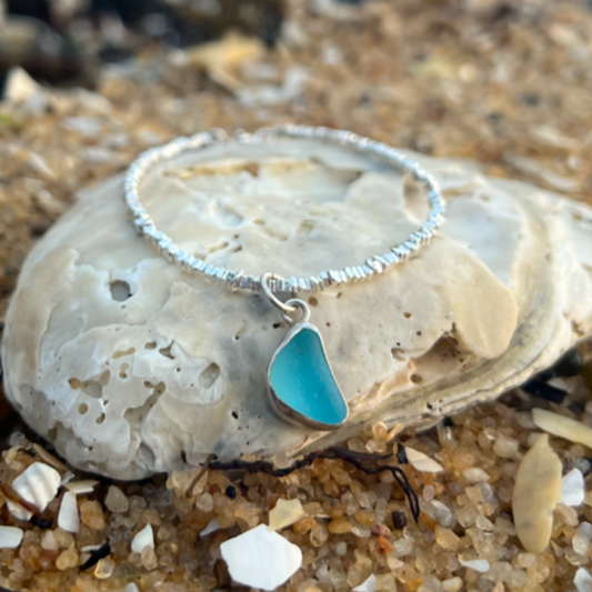 Blue sea glass set in silver surf bracelet by Mornington Sea Glass.
