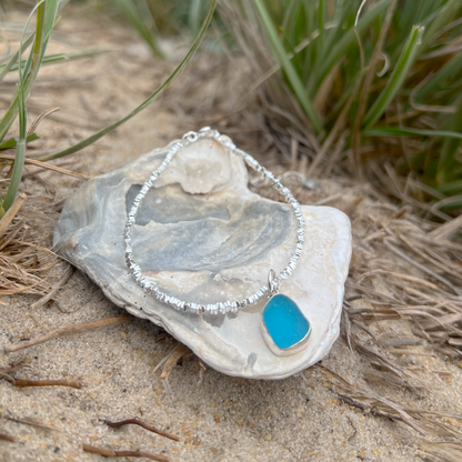 Blue sea glass set in silver surf bracelet by Mornington Sea Glass.