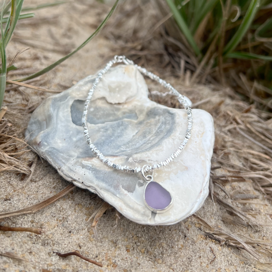 Purple sea glass set in silver surf bracelet by Mornington Sea Glass.