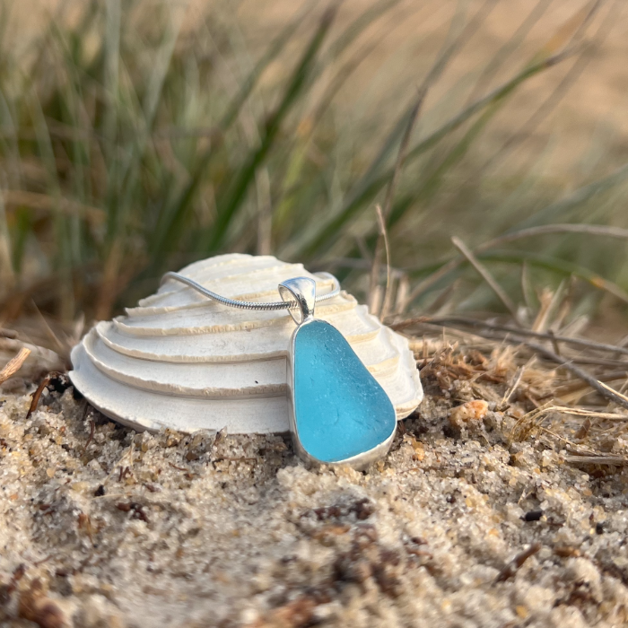 Blue sea glass set in silver pendant by Mornington Sea Glass. Hangs on a 40 or 45cm sterling silver snake chain.