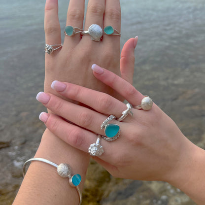 Hands modelling sea glass and cast silver shell rings and bangles by Mornington Sea Glass