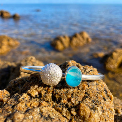 Solid sterling silver 65mm diameter bangle featuring a cast silver urchin and rare English blue multi colour sea glass By Mornington Sea Glass.