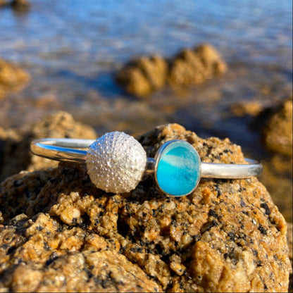 Solid sterling silver 65mm diameter bangle featuring a cast silver urchin and rare English blue multi colour sea glass By Mornington Sea Glass.