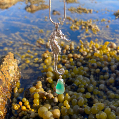 Sterling silver necklace of a cast silver seahorse with a rare English multi colour green, yellow and white sea glass treasure. Hangs on a 40 or 45cm sterling silver chain. By Mornington Sea Glass.