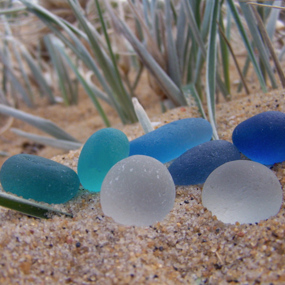 Sea glass egg shapes in blue, teal and white. Photographed by Mornington Sea Glass.