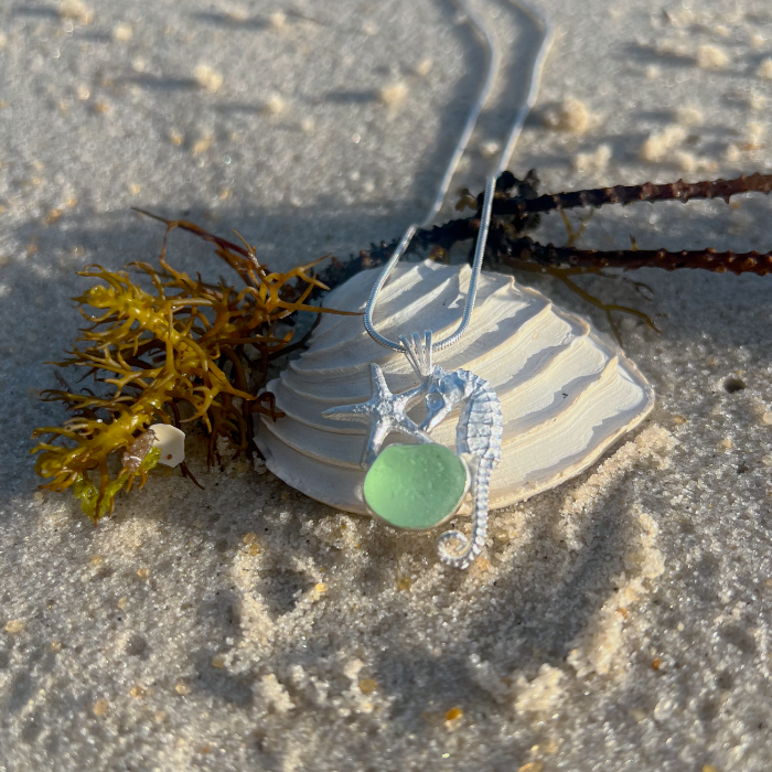 Sterling silver necklace of a small cast silver seahorse, sea star  and seafoam sea glass treasure. Hangs on a 40 or 45cm sterling silver chain. By Mornington Sea Glass.
