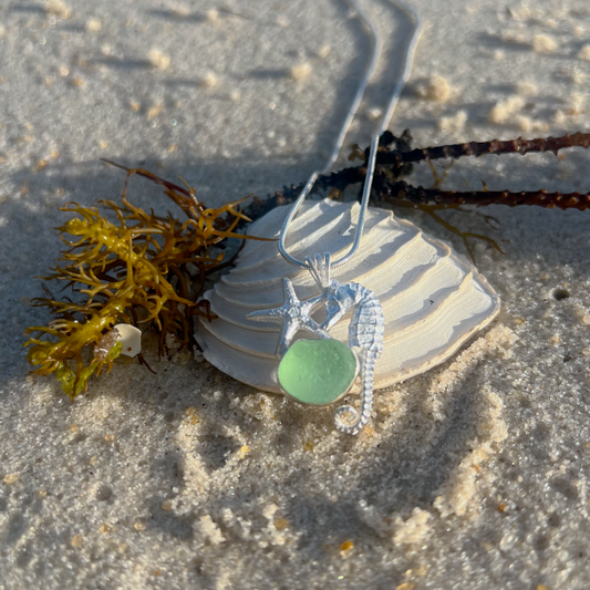 Sterling silver necklace of a small cast silver seahorse, sea star  and seafoam sea glass treasure. Hangs on a 40 or 45cm sterling silver chain. By Mornington Sea Glass.