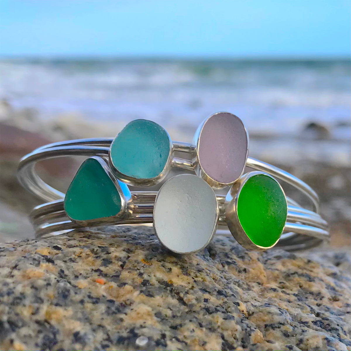 Purple, aqua, white and blue sea glass stacking bangles by Mornington Sea Glass photographed at the beach on the Mornington Peninsula, Victoria, Australia