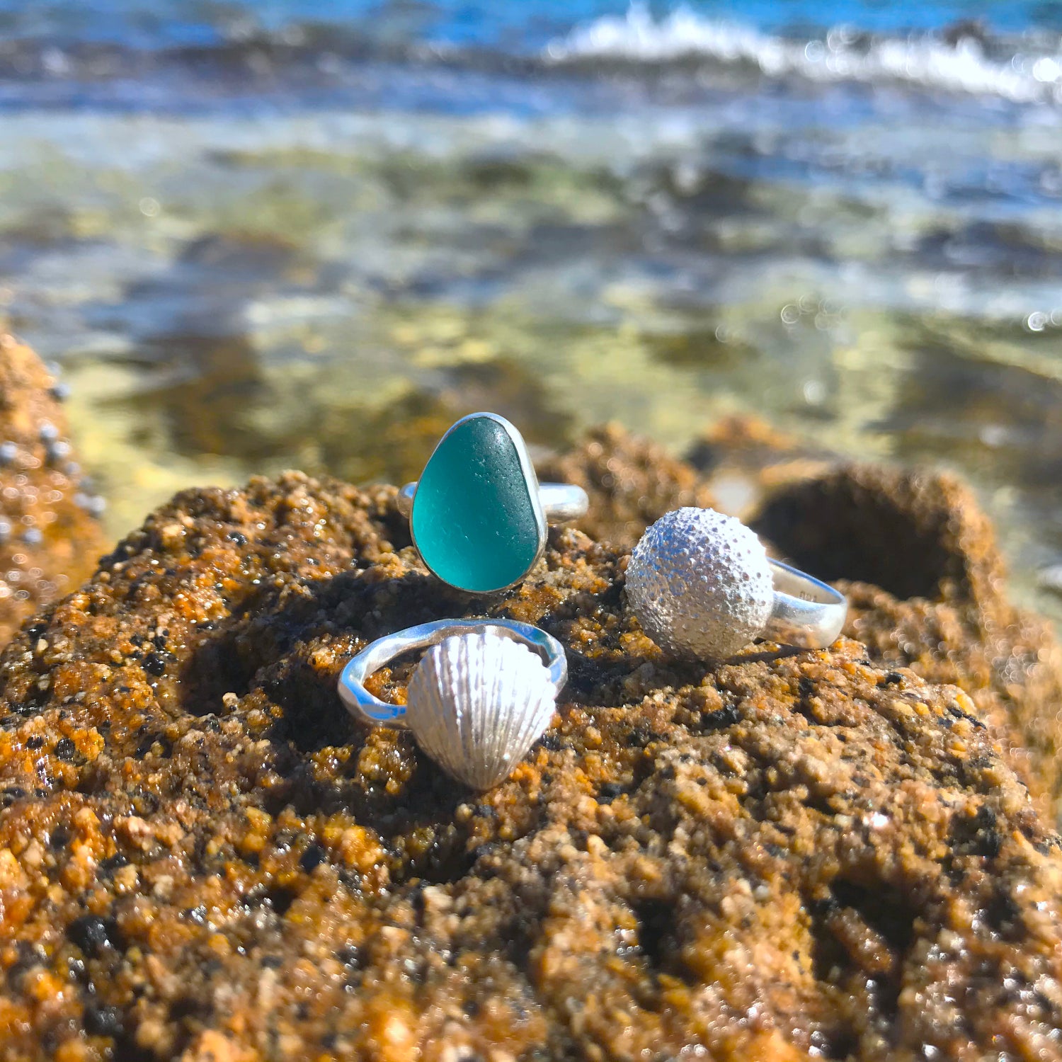 Blue sea glass ring and cast silver shell rings by Mornington Sea Glass. Photographed at the rock pools on the Mornington Peninsula, Victoria, Australia.