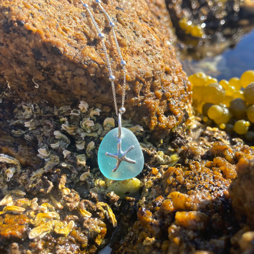 Ocean blue sea glass sea star pendant by Mornington Sea Glass photographed at rock pools on the Mornington Peninsula, Victoria, Australia