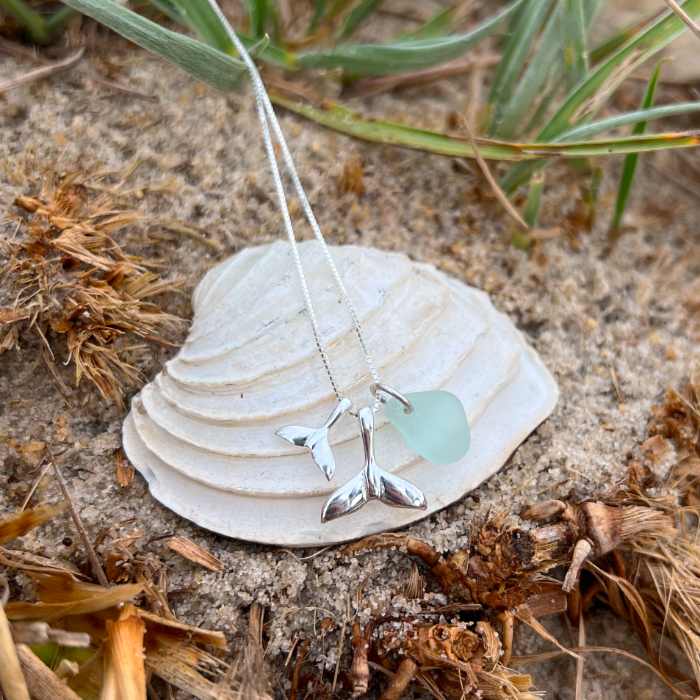 Soft seafoam blue sea glass and two whale tail charms necklace by Mornington Sea Glass. Hangs on a fine box chain 40cm plus 4cm extension.