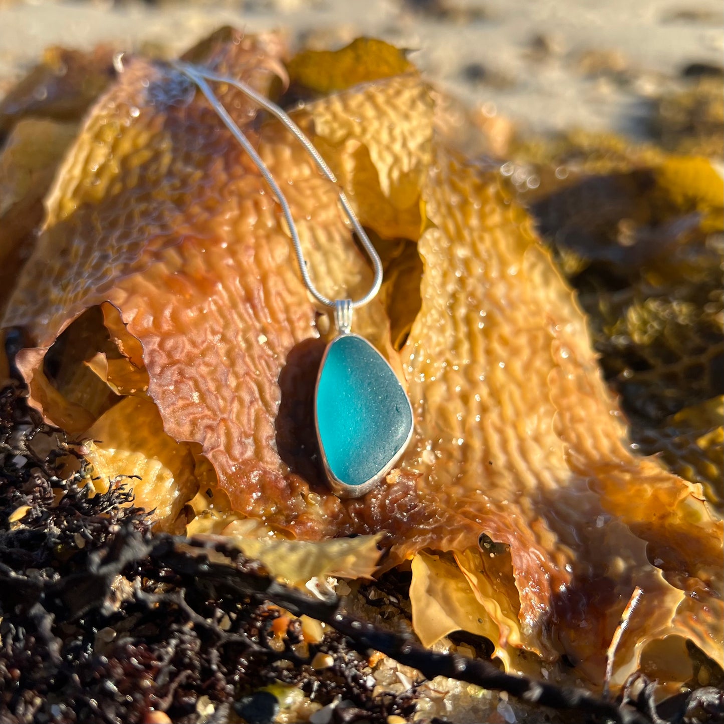 Ocean Teal sea glass set in silver pendant by Mornington Sea Glass. Hangs on a 40 or 45cm sterling silver snake chain.