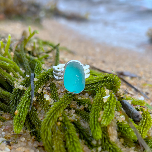 Ocean teal sea glass set in silver on a cast driftwood inspired silver ring band by Mornington Sea Glass. Size 6 3/4.