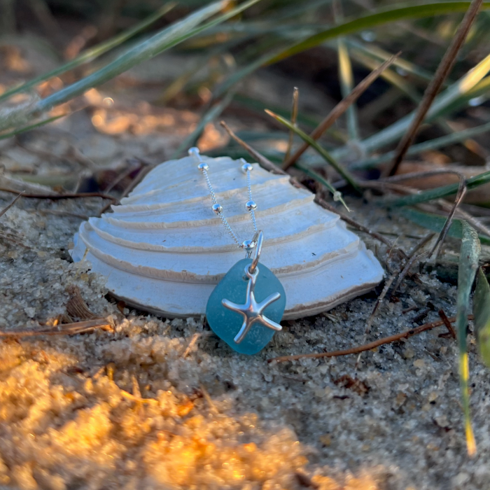 Ocean teal sea glass and sterling silver starfish pendant by Mornington Sea Glass. Hangs on a 40cm + 5cm extension ball detail chain.