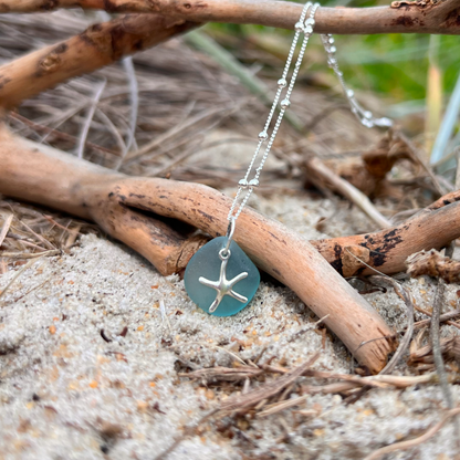 Ocean teal sea glass and sterling silver starfish pendant by Mornington Sea Glass. Hangs on a 40cm + 5cm extension ball detail chain.