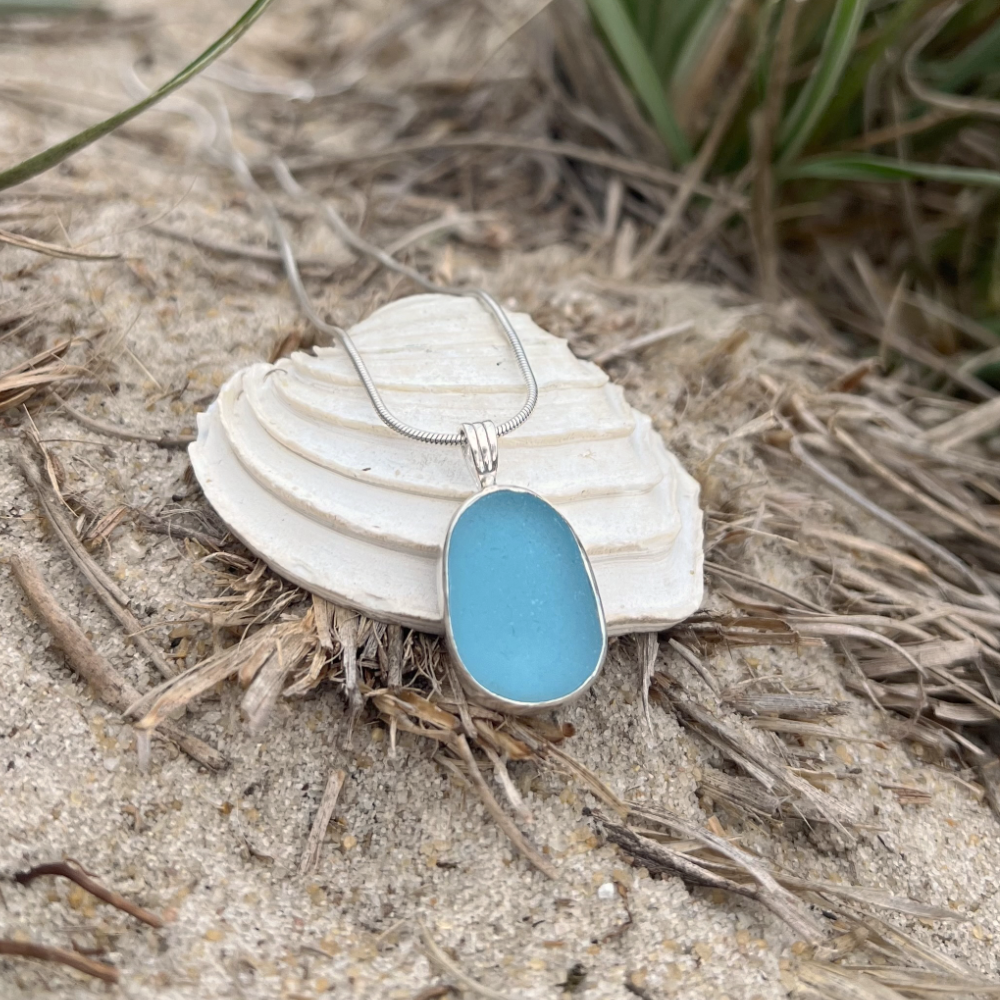 Ocean teal sea glass set in silver pendant by Mornington Sea Glass. Hangs on a 40 or 45cm sterling silver snake chain.