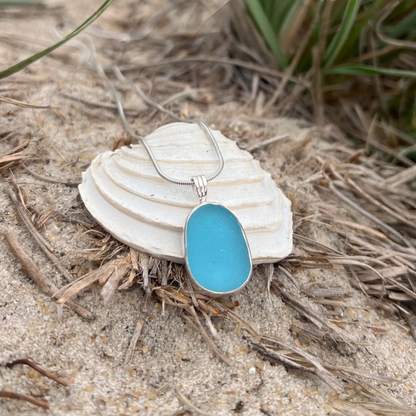 Ocean teal sea glass set in silver pendant by Mornington Sea Glass. Hangs on a 40 or 45cm sterling silver snake chain.