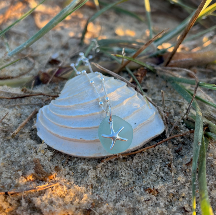 Pale seafoam blue sea glass and sterling silver starfish pendant by Mornington Sea Glass. Hangs on a 40cm + 5cm extension ball detail chain.