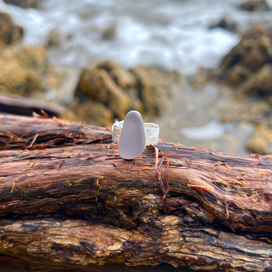 Purple sea glass set in silver on a cast beach feather inspired silver ring band by Mornington Sea Glass. Size 7 1/2.