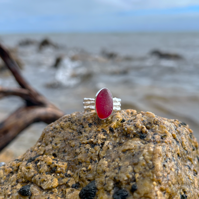 Rare red sea glass set in silver on a cast driftwood inspired silver ring band by Mornington Sea Glass. Size 8.
