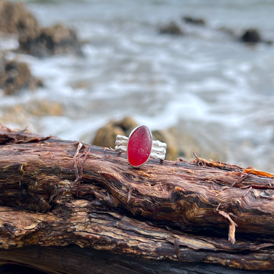 Rare red sea glass set in silver on a cast driftwood inspired silver ring band by Mornington Sea Glass. Size 8.