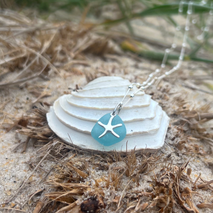 Ocean teal sea glass and sterling silver starfish pendant by Mornington Sea Glass. Hangs on a 40cm + 5cm extension ball detail chain.