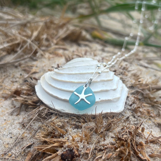 Ocean teal sea glass and sterling silver starfish pendant by Mornington Sea Glass. Hangs on a 40cm + 5cm extension ball detail chain.